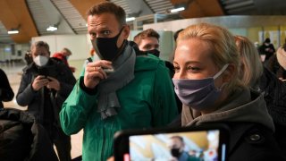 Alexei Navalny and his wife Yuliastand in line at the passport control after arriving at Sheremetyevo airport, outside Moscow, Russia, Sunday, Jan. 17, 2021. Russia's prison service says opposition leader Alexei Navalny has been detained at a Moscow airport after returning from Germany.