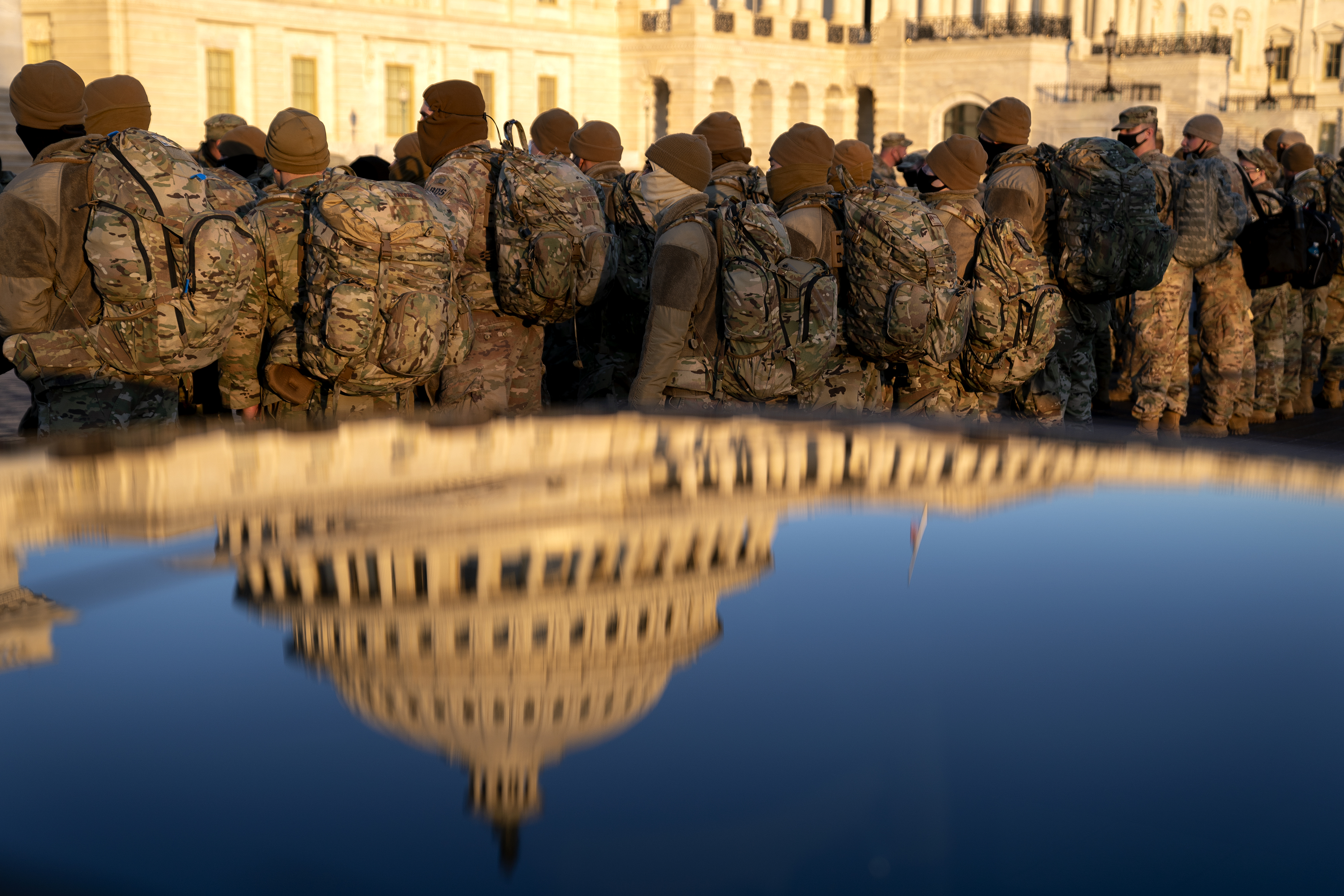 WASHINGTON, DC &#8211; JANUARY 12: Members of the National Guard gather outside the U.S. Capitol on January 12, 2021 in Washington, DC. Today the House of Representatives plans to vote on Rep. Jamie Raskin&#8217;s (D-MD) resolution calling on Vice President Mike Pence to invoke the 25th Amendment, removing President Trump from office. Wednesday, House Democrats plan on voting on articles of impeachment. (Photo by Stefani Reynolds/Getty Images)