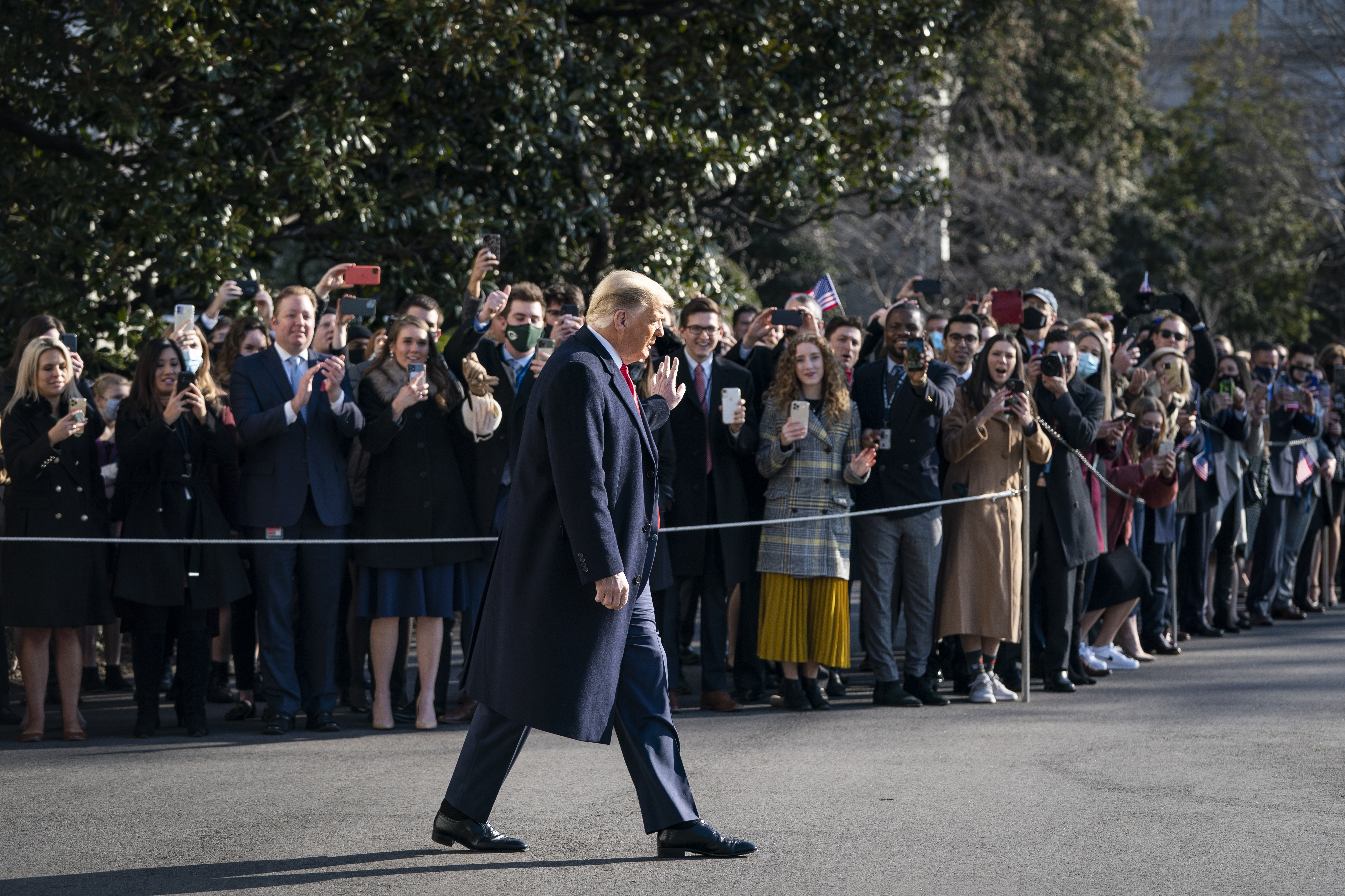 WASHINGTON, DC &#8211; JANUARY 12: U.S. President Donald Trump waves to staff and supporters as he walks toward Marine One on the South Lawn of the White House on January 12, 2021 in Washington, DC. Following last week&#8217;s deadly pro-Trump riot at the U.S. Capitol, President Trump is making his first public appearance with a trip to the town of Alamo, Texas to view the construction of the wall along the U.S.-Mexico border. (Photo by Drew Angerer/Getty Images)