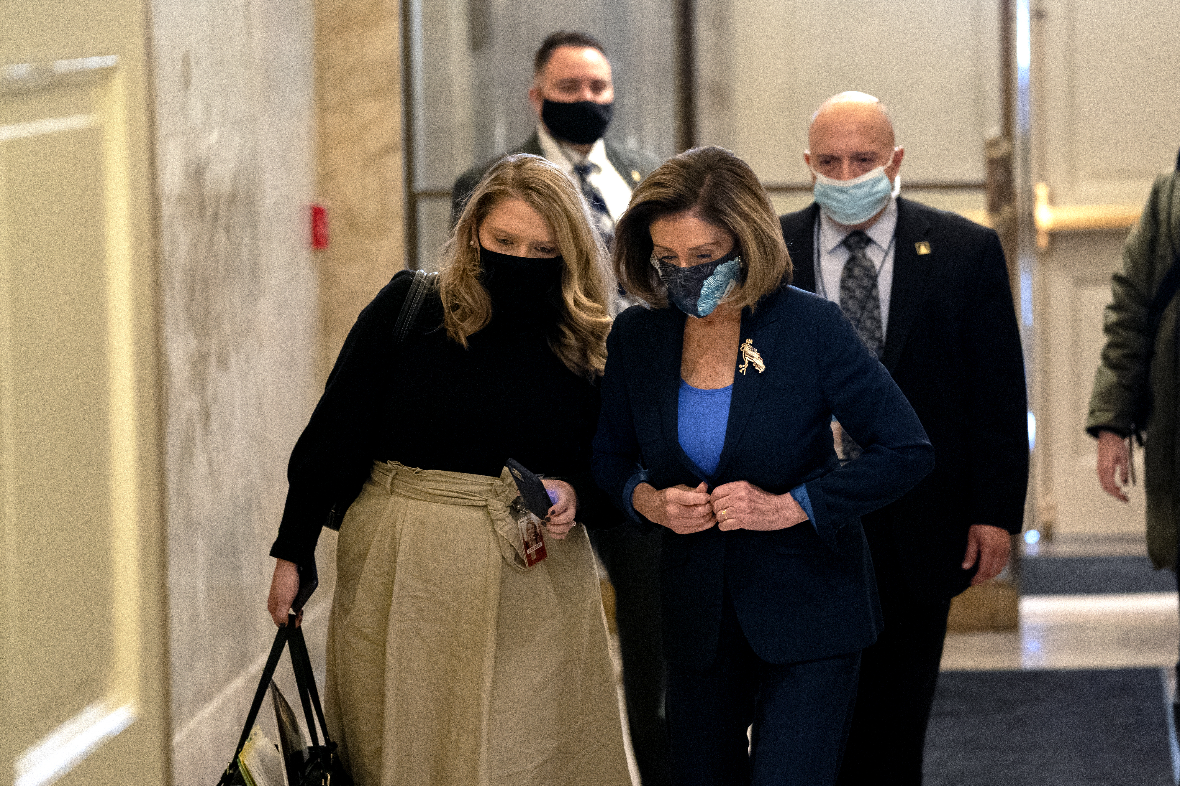 WASHINGTON, DC &#8211; JANUARY 12: Speaker of the House Nancy Pelosi (D-CA) (C) wears a protective mask while arriving to the U.S. Capitol on January 12, 2021 in Washington, DC. Today the House of Representatives plans to vote on Rep. Jamie Raskin&#8217;s (D-MD) resolution calling on Vice President Mike Pence to invoke the 25th Amendment, removing President Trump from office. On Wednesday, House Democrats plan on voting on articles of impeachment. (Photo by Stefani Reynolds/Getty Images)