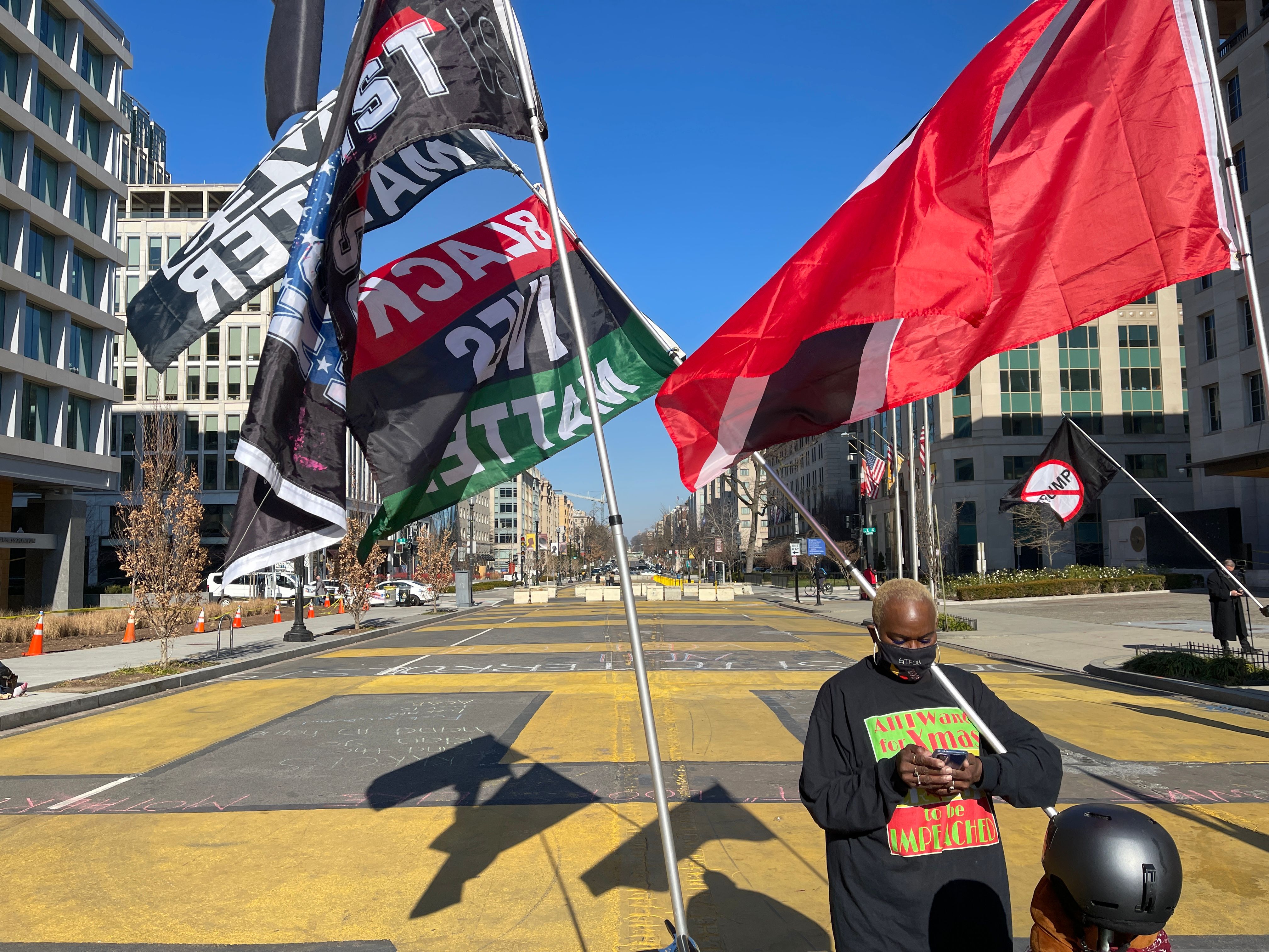 People hold flags in a near empty Black Live Matter Plaza, ahead of the Inauguration of Joe Biden on January 20, in Washington DC, on January 12, 2021. &#8211;  (Photo by Daniel SLIM / AFP)