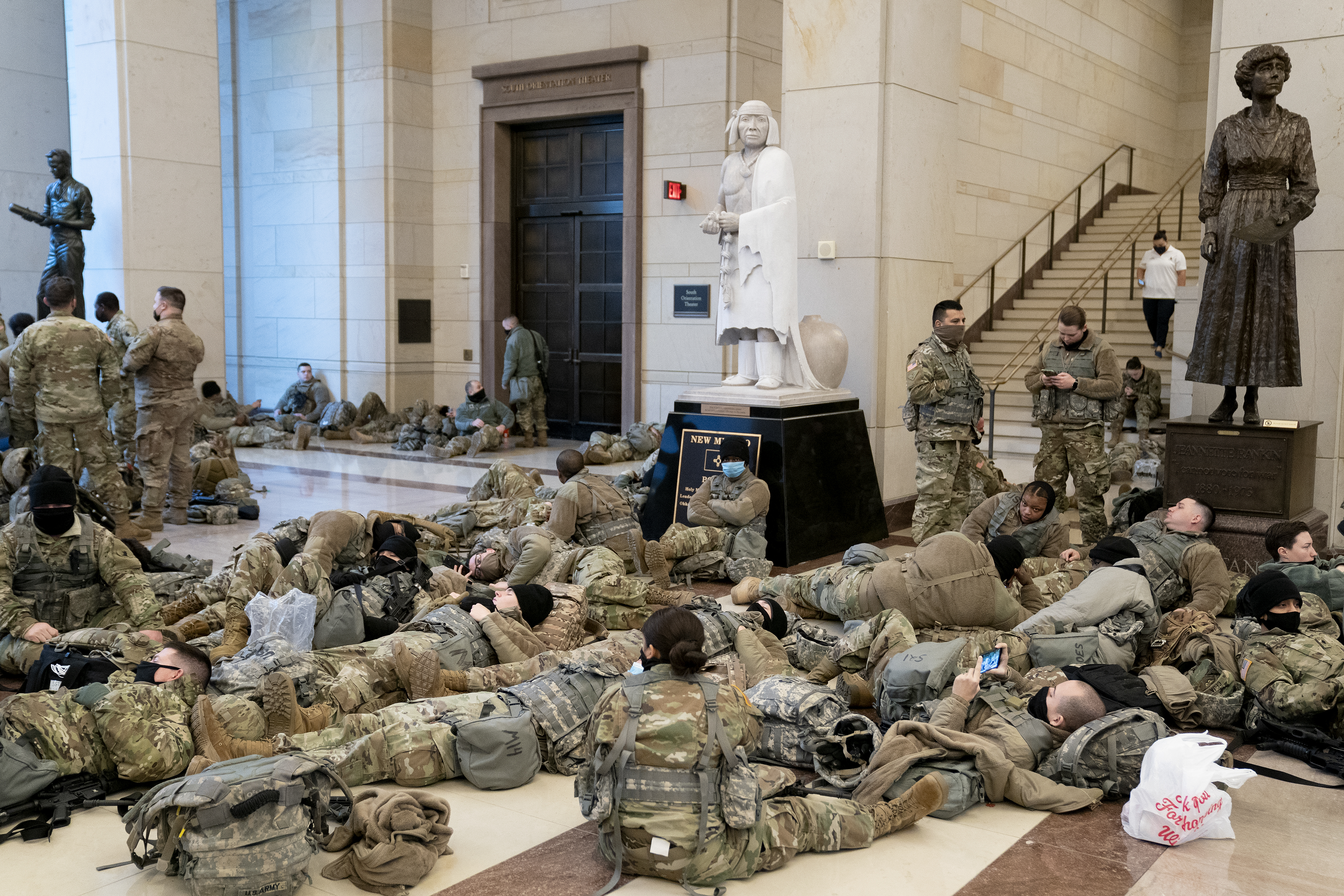 WASHINGTON, DC &#8211; JANUARY 13: Members of the National Guard rest in the Visitor Center of the U.S. Capitol on January 13, 2021 in Washington, DC. Security has been increased throughout Washington following the breach of the U.S. Capitol last Wednesday, and leading up to the Presidential inauguration. (Photo by Stefani Reynolds/Getty Images)