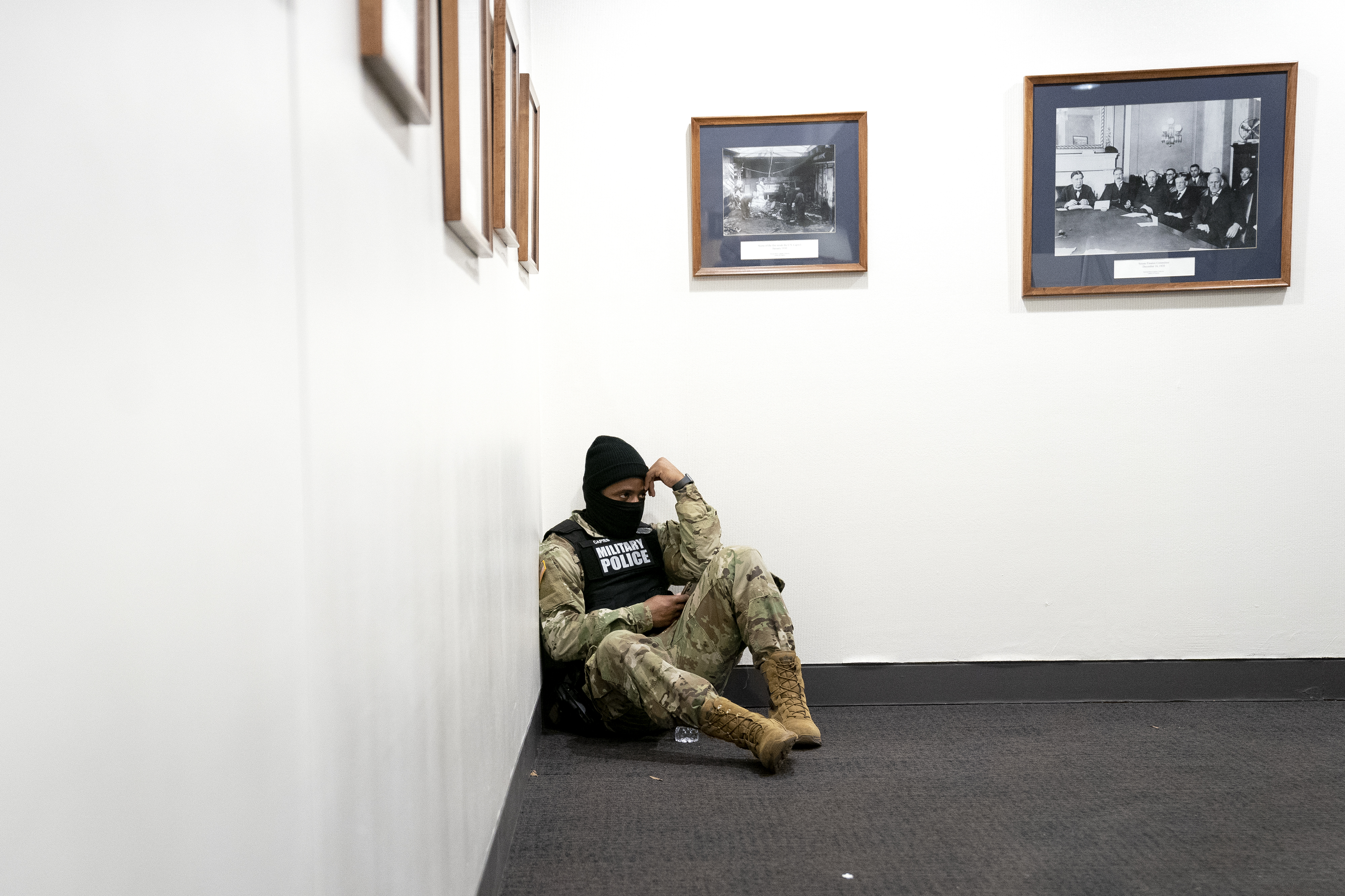 WASHINGTON, DC &#8211; JANUARY 14: A member of the National Guard sits in the Dirksen Senate Office Building on Capitol Hill on January 14, 2021 in Washington, DC. Security has been increased throughout Washington following the breach of the U.S. Capitol last Wednesday, and leading up to the Presidential inauguration. (Photo by Stefani Reynolds/Getty Images)
