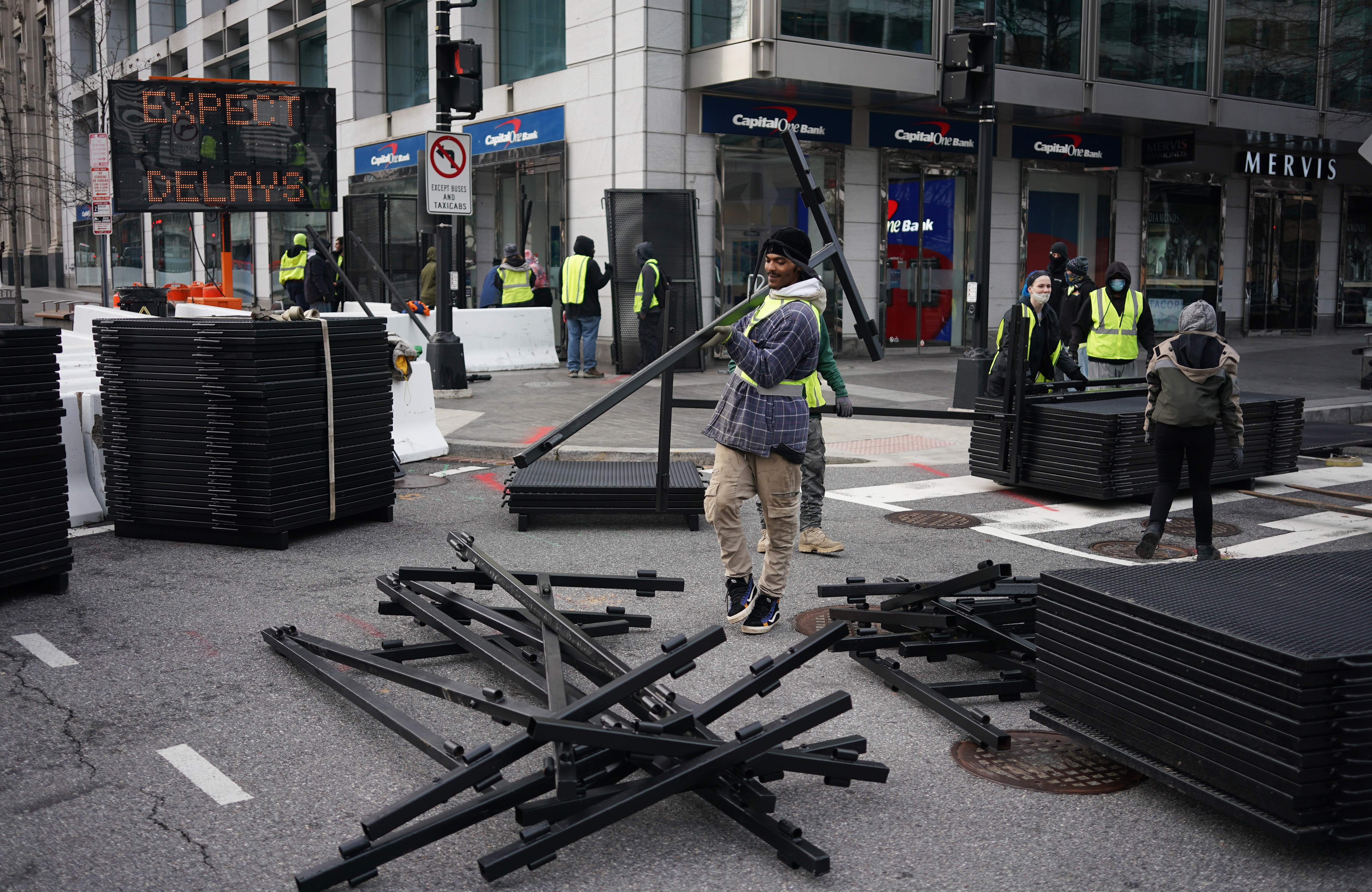 Workers unload security fencing  near the White House in Washington, DC on January 14, 2021. &#8211; Security in Washington is being tightened ahead of the inauguration of President-elect Joe Biden on January 20, 2021. (Photo by MANDEL NGAN / AFP)