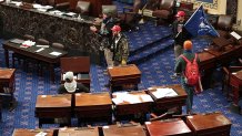 Larry Rendell Brock of Grapevine confirmed to The New Yorker Saturday that this photo shows him in the Senate Chamber on Jan. 6, 2021 in Washington, DC. Brock is pictured in combat gear in the top portion of the photo.