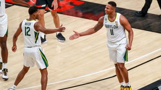 Guards Mark Vital #11 and Jared Butler #12 of the Baylor Bears high five during the first half of the college basketball game against the Texas Tech Red Raiders at United Supermarkets Arena on Jan. 16, 2021 in Lubbock, Texas.