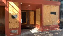 A storefront is boarded up near the Texas Capitol, which closed through Wednesday due to threat of armed protests, in Austin, Texas on Saturday, Jan. 16, 2021.