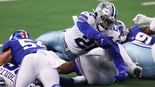 Ezekiel Elliott #21 of the Dallas Cowboys dives for a touchdown against the New York Giants during the second quarter at AT&T Stadium on Oct. 11, 2020 in Arlington, Texas.