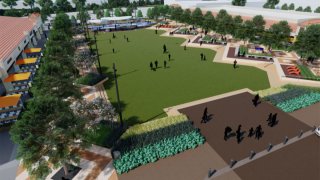 Design of Hillcrest Village park. It has a large green area with trees stretching down the length of the green field. Behind the trees are restaurants. On onw wide side of the design is a play area for children. The other wide side contains small plants.