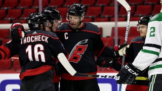 Vincent Trocheck #16 of the Carolina Hurricanes scores a goal and celebrates with teammates during an NHL game against the Dallas Stars on Jan. 30, 2021 at PNC Arena in Raleigh, North Carolina.