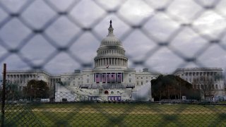 In this Jan. 17, 2021, file photo, the U.S. Capitol is seen behind fences in Washington, D.C.