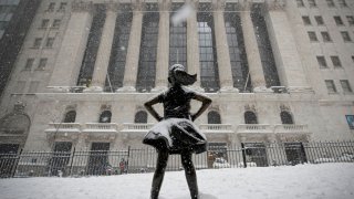 The “Fearless Girl” sculpture is seen outside the New York Stock Exchange (NYSE) during a snow storm in New York, February 1, 2021.