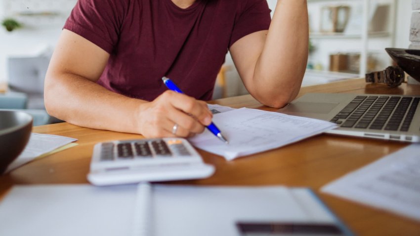 Young man at home, paying bills online