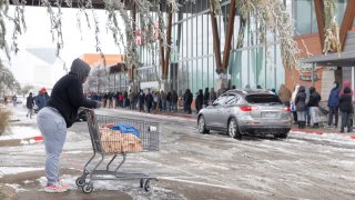 People wait in line outside one of a HEB Grocery Co. grocery store in Austin, Texas, U.S., on Wednesday, Feb. 17, 2021. The crisis that has knocked out power for days to millions of homes and businesses in Texas and across the central U.S. is getting worse, with blackouts expected to last until at least Thursday.