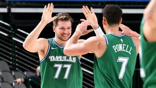 Luka Doncic #77 of the Dallas Mavericks high fives Dwight Powell #7 of the Dallas Mavericks during the game against the Minnesota Timberwolves on Feb. 8, 2021 at the American Airlines Center in Dallas, Texas.