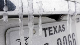 Icicles formed over a vehicle's Texas license plate amid snowstorms and a record-breaking cold snap, Feb. 15, 2021.