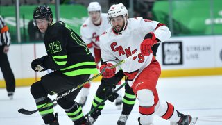 Vincent Trocheck #16 of the Carolina Hurricanes battles for position against Mark Pysyk #13 of the Dallas Stars at the American Airlines Center on Feb. 13, 2021 in Dallas, Texas.