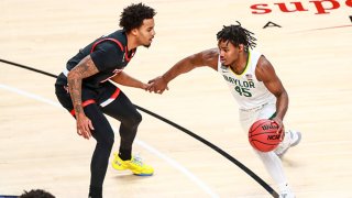 Guard Davion Mitchell #45 of the Baylor Bears handles the ball against guard Kyler Edwards #11 of the Texas Tech Red Raiders during the first half of the college basketball game at United Supermarkets Arena on Jan. 16, 2021 in Lubbock, Texas.