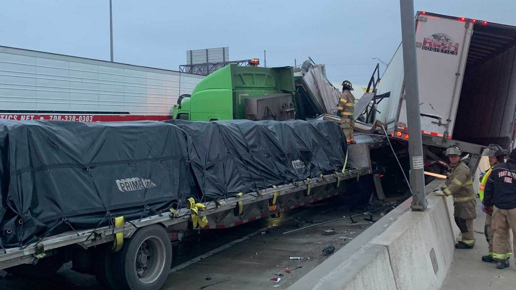 Firefighters respond to a multi-vehicle pileup in Fort Worth Thursday morning after thin sheets of ice formed on North Texas highways overnight.
