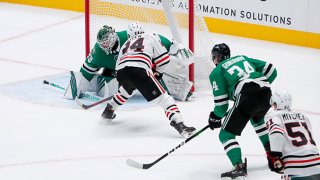 Pius Suter #24 of the Chicago Blackhawks scores the game-winning goal against Jake Oettinger #29 of the Dallas Stars in overtime at American Airlines Center on Feb. 9, 2021 in Dallas, Texas.
