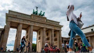 Tourists gather in front of Berlin’s iconic Brandenburg Gate on August 4, 2020.
