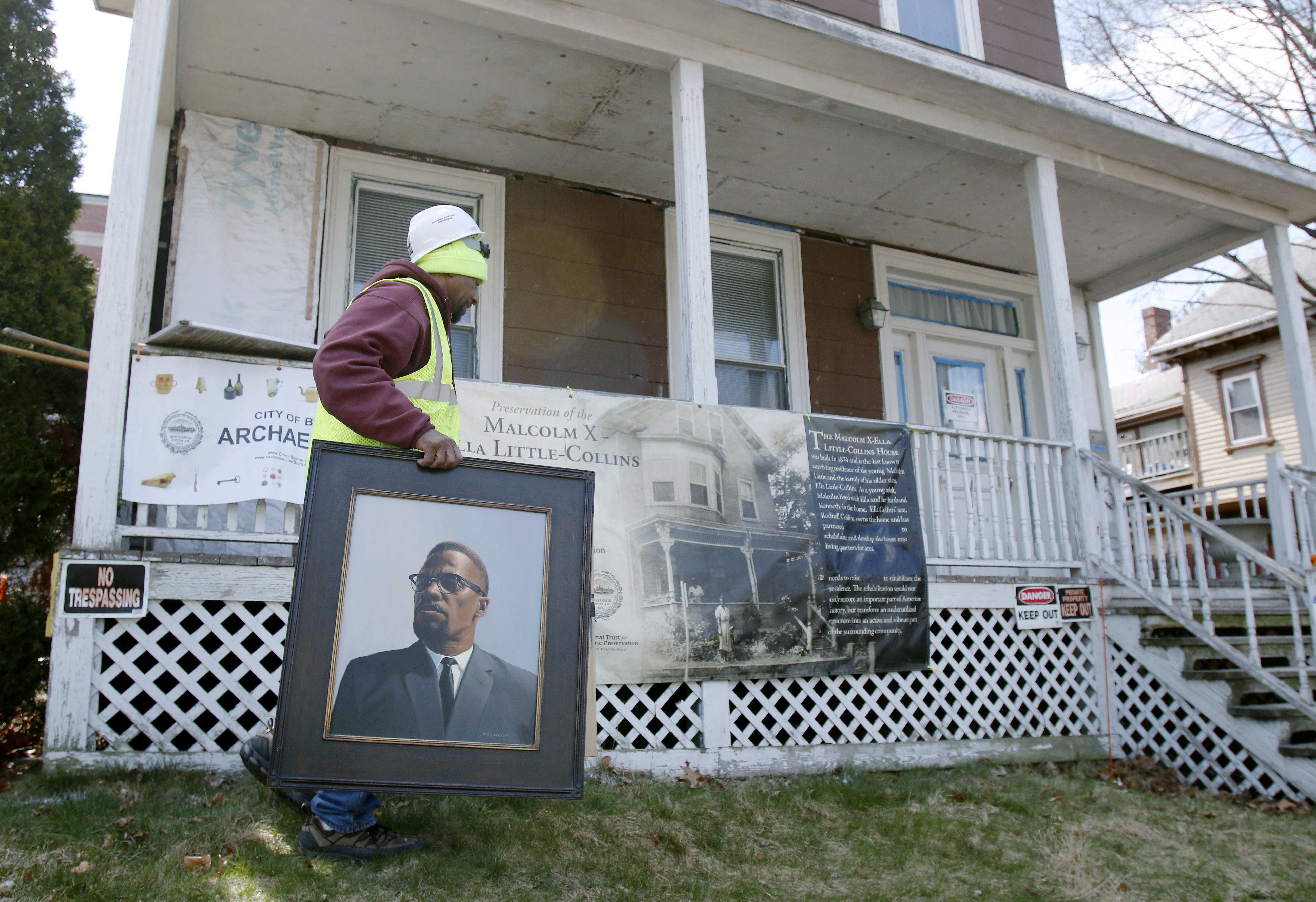 Rodnell P. Collins carries a painting of his uncle, Malcolm X