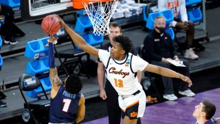 Oklahoma State forward Matthew-Alexander Moncrieffe (12) blocks the shot of Liberty's Chris Parker during the first half of a first round NCAA college basketball game Friday, March 19, 2021, at the Indiana Farmers Coliseum in Indianapolis.