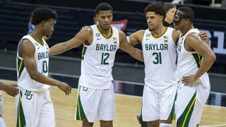 Baylor Bears players gather mid court after winning the game against the Kansas State Wildcats on March 11, 2021 at the T Mobile Center in Kansas City, Missouri.