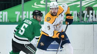 Filip Forsberg #9 of the Nashville Predators tries to keep the puck away against Andrej Sekera #5 of the Dallas Stars at the American Airlines Center on March 21, 2021 in Dallas, Texas.