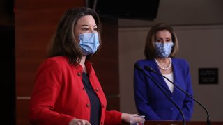 Representative Angie Craig, a Democrat from Minnesota, wears a protective mask while speaking during a new conference with U.S. House Speaker Nancy Pelosi, a Democrat from California, right, at the U.S. Capitol in Washington, D.C., U.S., on Friday, March 19, 2021.