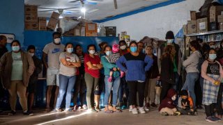 Asylum seekers attend a meeting at an immigrant shelter on March 16, 2021 in Ciudad Juarez, Mexico. A surge of immigrant families and as many as 13,000 unaccompanied minors now in U.S. custody, according to CBS News, is causing a humanitarian crisis at the U.S.-Mexico border.