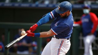 Joey Gallo #13 of the Texas Rangers fouls off a pitch against the Los Angeles Dodgers during the fifth inning of the MLB spring training baseball game at Surprise Stadium on March 7, 2021 in Surprise, Arizona.