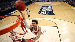 Justin Smith #0 of the Arkansas Razorbacks drives to the basket against Terrence Shannon Jr. #1 of the Texas Tech Red Raiders during the first half in the second round game of the 2021 NCAA Men's Basketball Tournament at Hinkle Fieldhouse on March 21, 2021 in Indianapolis, Indiana.