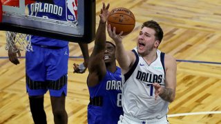 Luka Doncic #77 of the Dallas Mavericks drives to the basket against Dwayne Bacon #8 of the Orlando Magic during the second half at Amway Center on March 1, 2021 in Orlando, Florida.