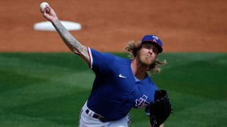Starting pitcher Mike Foltynewicz #20 of the Texas Rangers throws against the Los Angeles Dodgers during the second inning of the MLB spring training baseball game at Surprise Stadium on March 7, 2021 in Surprise, Arizona.