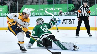 Roman Josi #59 of the Nashville Predators dekes around Jake Oettinger #29 of the Dallas Stars for the game winning shoot out goal at the American Airlines Center on March 7, 2021 in Dallas, Texas.