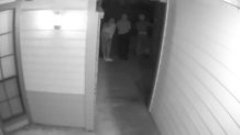Three Individuals in Doorway
