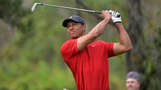 FILE - Tiger Woods watches his tee shot on the fourth hole during the final round of the PNC Championship golf tournament in Orlando, Fla., on Dec. 20, 2020.