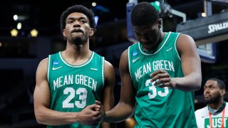 Mykell Robinson #23 and Abou Ousmane #33 of the North Texas Mean Green react after losing to the Villanova Wildcats in their second round game of the 2021 NCAA Men's Basketball Tournament at Bankers Life Fieldhouse on March 21, 2021 in Indianapolis, Indiana.