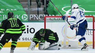 A shot gets through Anton Khudobin #35 of the Dallas Stars for a power play goal against the Tampa Bay Lightning at the American Airlines Center on March 23, 2021 in Dallas, Texas.