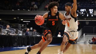 Ethan Thompson #5 of the Oregon State Beavers drives against Avery Anderson III #0 of the Oklahoma State Cowboys during the second half in the second round game of the 2021 NCAA Men's Basketball Tournament at Hinkle Fieldhouse on March 21, 2021 in Indianapolis, Indiana.