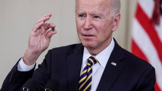 President Joe Biden holds a chip as he speaks prior to signing an executive order aimed at addressing a global semiconductor shortage, in the State Dining Room at the White House in Washington, U.S., February 24, 2021.