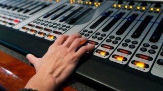 A hand on top of a sound board