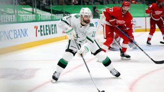 Andrew Cogliano #11 of the Dallas Stars skates the puck against the Detroit Red Wings in the second period at American Airlines Center on April 20, 2021 in Dallas, Texas.