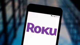 In this photo illustration the Roku logo is seen displayed on a smartphone.