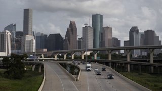 FILE: Traffic moves past the skyline of Houston, Texas, U.S., on Saturday, June 27, 2020.