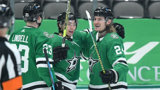 Esa Lindell #23, Jason Robertson #21 and Roope Hintz #24 of the Dallas Stars celebrate a goal against the Florida Panthers at the American Airlines Center on April 10, 2021 in Dallas, Texas.