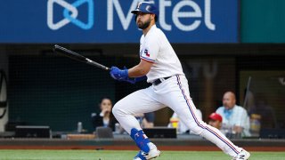 Joey Gallo #13 of the Texas Rangers singles against the San Diego Padres during the third inning at Globe Life Field on April 10, 2021 in Arlington, Texas.