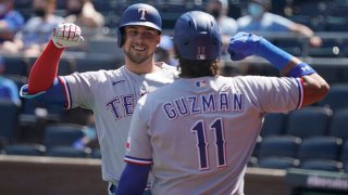 Nate Lowe #30 of the Texas Rangers celebrates his three-run home run with Ronald Guzman in the third inning against the Kansas City Royals at Kauffman Stadium on April 4, 2021 in Kansas City, Missouri.