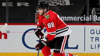 Patrick Kane #88 of the Chicago Blackhawks skates with the puck in the third period against the Dallas Stars at the United Center on April 6, 2021 in Chicago, Illinois.